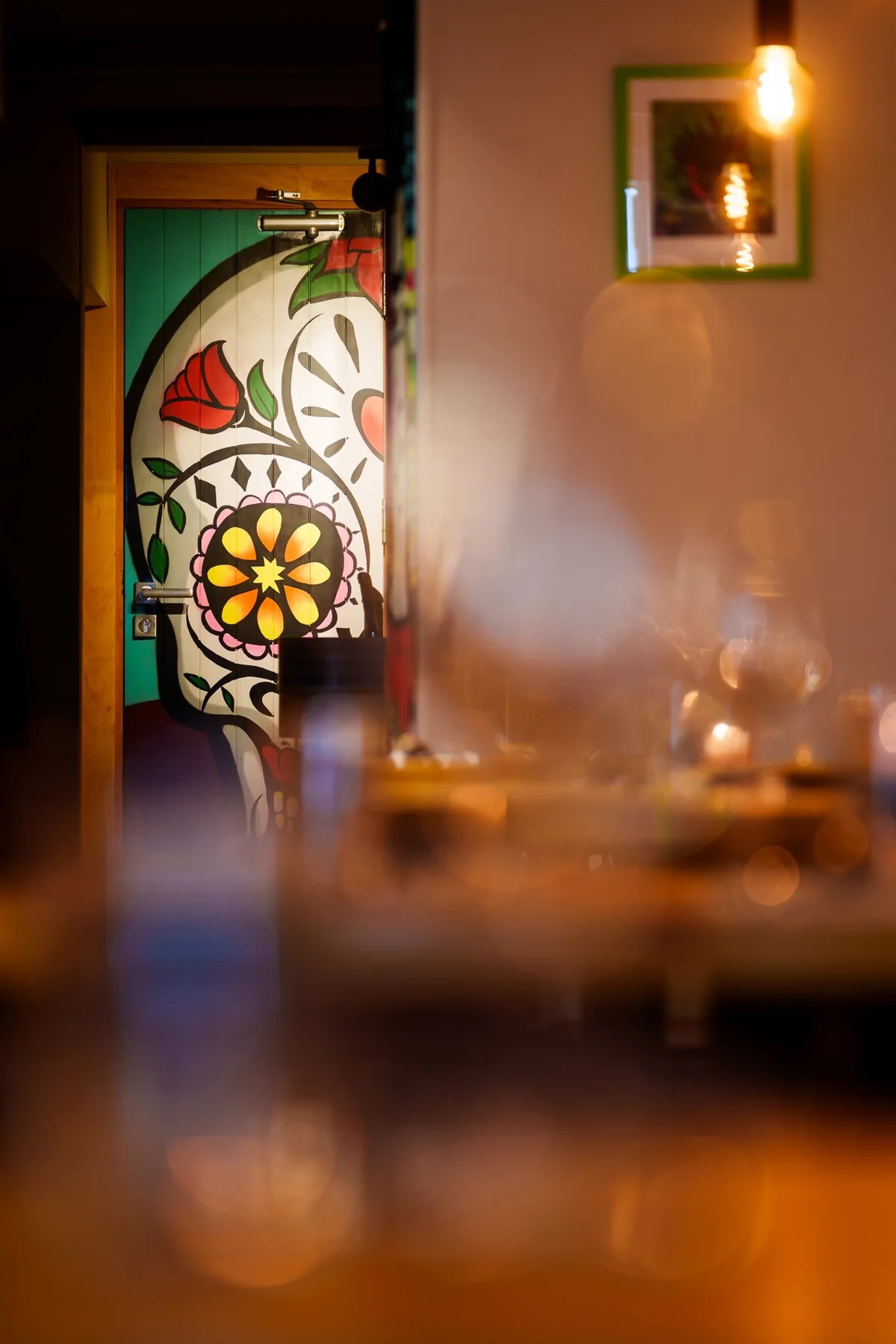 Decorative artwork and warm lighting at Copal
